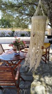 a chandelier hanging over a picnic table under a tree at Vanna's Holiday House in Ierissos