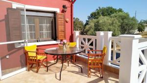 a patio with a table and chairs on a balcony at Vanna's Holiday House in Ierissos