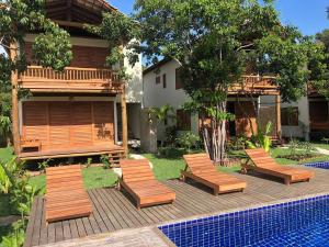 a group of chairs sitting next to a pool at Cond ReservaTaipu, apart 202 in Barra Grande