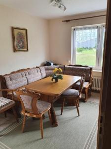 a living room with a table and a couch at Ferienhaus-Naturblick in Berndorf