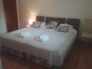 a bedroom with a large white bed with towels on it at MILDA+M in Skradin +51 photos
