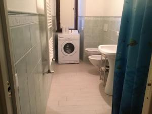 a bathroom with a washing machine and a washer at Albergo Ristorante La Rocca in Firenzuola