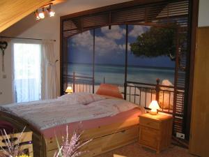 a bedroom with a bed with a view of the ocean at Gästehaus Regina in Ruhla