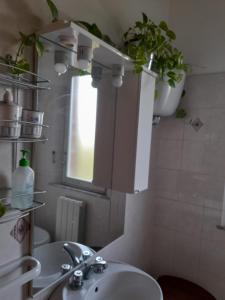 a bathroom with a sink and a mirror at Casa Patti alle porte di Siena in Siena