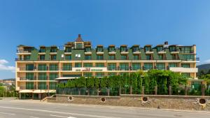 a large building on the side of a road at Hotel Julia in Sveti Vlas