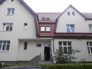 a white house with a red roof at Villa Superiq Victus Sopot Walk to the Pier by Noclegi Renters in Sopot +30 photos