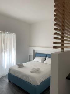 a bedroom with a bed with two towels on it at Blue Bay Suite & Spa in Agropoli +42 photos