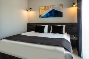 Postel nebo postele na pokoji v ubytování Lorem Hotel