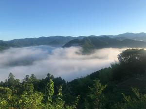 a view of a valley of clouds in the mountains at Hatago Masara - Vacation STAY 30108v in Tanabe