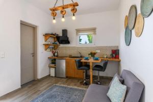 a living room with a table and a kitchen at Live & Dream in Vrisi/ Mykonos