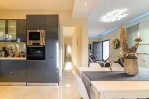 a kitchen and living room with stainless steel appliances at Villa Marilena in Corfu Town