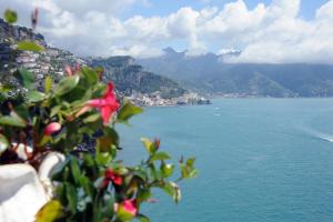 a view of a body of water with mountains at Hotel Belvedere in Conca dei Marini