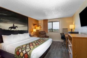 A bed or beds in a room at Super 8 by Wyndham Cheyenne WY