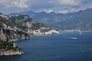 a view of a large body of water with mountains at Hotel Belvedere in Conca dei Marini
