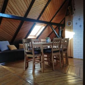 a dining room with a table and chairs in a attic at Willa Sielsko Anielsko in Szklarska Poręba