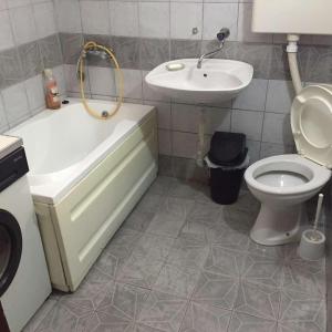 a bathroom with a tub and a toilet and a sink at HOSTEL EMI in Kavadarci +27 photos
