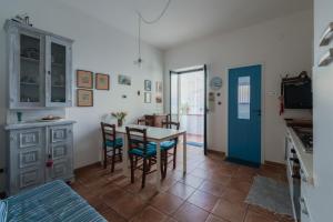 a kitchen and dining room with a table and chairs at Casa di Sale - Chianalea in Scilla