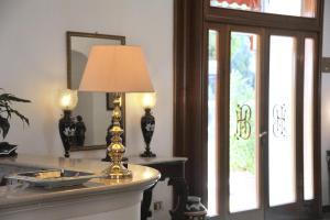 a lamp sitting on top of a table next to a window at Hotel Belvedere in Conca dei Marini