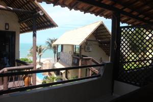 a balcony of a house with a view of the ocean at Pousada Mundial in Canoa Quebrada