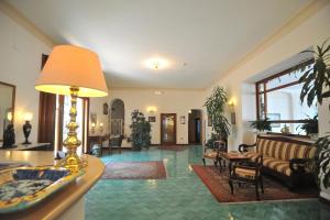 a living room with a couch and a table at Hotel Belvedere in Conca dei Marini