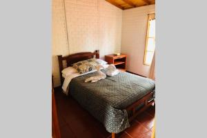 een slaapkamer met een bed met twee handdoeken erop bij CABAÑA BUENAVISTA es un lugar para descansar. in Iza