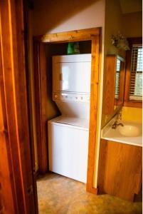 a kitchen with a white refrigerator and a sink at Mountain Aire Cottages, Inn, & Glamping in Clayton +289 photos