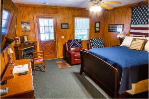 a bedroom with a bed and a couch and a chair at Mountain Aire Cottages, Inn, & Glamping in Clayton