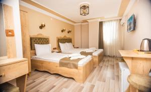 Postel nebo postele na pokoji v ubytování Hotel Orkide