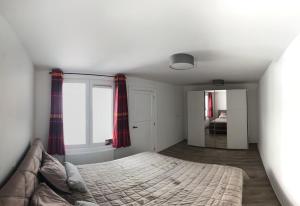 a bedroom with a bed and a window at Suite Christina in Ostend +5 photos