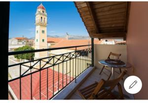 a balcony with a view of a clock tower at Evelina 3 in Lixouri