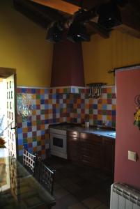una cocina con azulejos de colores en las paredes en Casa Rural El Regajo, en Tenzuela