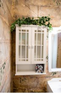 a window on a stone wall with a plant at Mountain Aire Cottages, Inn, & Glamping in Clayton
