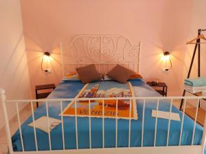 a bedroom with a bed with a blue comforter at Nel cuore di Genova BAGNO PRIVATO in Genoa
