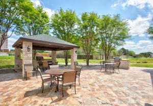 a pavilion with tables and chairs on a patio at Candlewood Suites Dallas Fort Worth South by IHG in Fort Worth