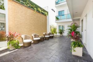 a courtyard with chairs and plants in a building at Quinta Santa Anita in Playa del Carmen