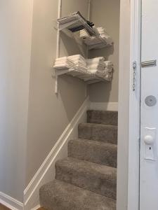 a stair case with stairs with towels and newspapers at Hyde Park Hideaway - Close to Square & Downtown! in Cincinnati