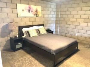 a bedroom with a bed and a wall with a mirror at Modern 2 Bdrm w/Parking in the Heart of Hillcrest in San Diego