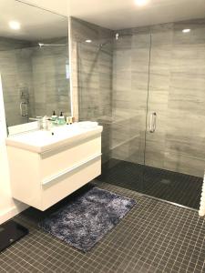 a bathroom with a sink and a shower at Modern 2 Bdrm w/Parking in the Heart of Hillcrest in San Diego