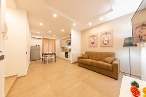 a living room with a couch and a table at I Mori Apartments in Cefalù