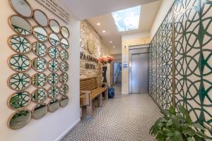 a hallway with a wall of stained glass windows at Paamonim Hotel Jerusalem in Jerusalem