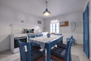 a kitchen with a table and chairs and a kitchen with a stove at Kuća za odmor Tonka in Grižane