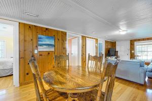 a dining room with a table and chairs and a bedroom at Cozy Corner in Folly Beach +14 photos