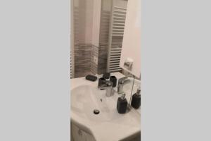 a bathroom with a white sink and a mirror at Casa Martina in Asti