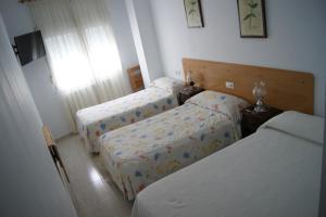 a bedroom with two beds and a window at Gran Vía in Lugo