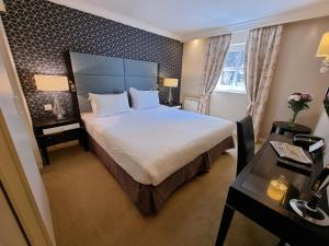 a hotel room with a large bed and a desk at Number Four at Stow in Stow on the Wold