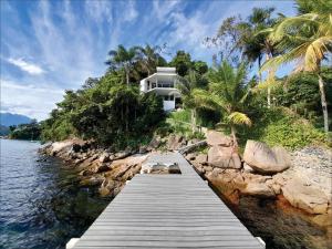a house on the shore of a body of water at Astangra Residence in Angra dos Reis