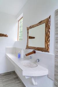 a bathroom with a sink and a mirror at Villas Ecotucan in Bacalar