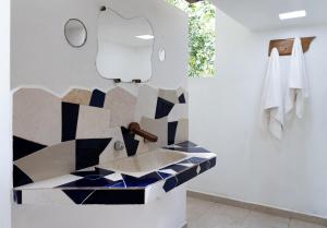 a bathroom with a counter with blue and white tiles at Villas Ecotucan in Bacalar