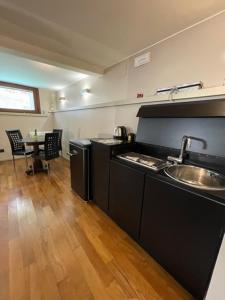 a kitchen with a sink and a table in a room at San Marco apartment with CANAL VIEW in Venice