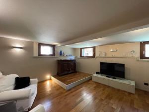 a living room with a couch and a flat screen tv at San Marco apartment with CANAL VIEW in Venice